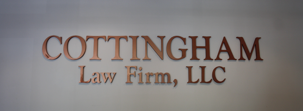 Cottingham Law Firm, LLC sign in copper letters on the office wall